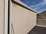 a white building with a yellow sign on it