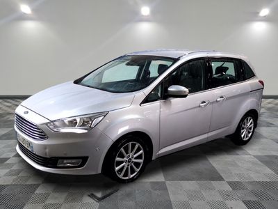 a silver minivan parked in a room with a checkered floor