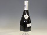 the bottle of wine is sitting on the table ready to be eaten