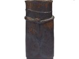 a rusted vase sitting on a white surface