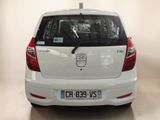 a white car that is parked in a room