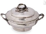 an antique silver plated casserole dish with handles and handles