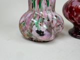 two vases sitting next to each other on a table