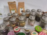 many jars and spoons that are sitting on a table