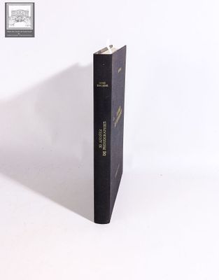 the book is sitting on a white surface next to a white wall