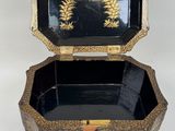 an image of a black and gold box sitting on top of a table