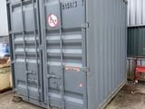a large gray container sitting in front of a building