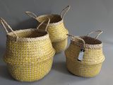 three woven baskets with handles and handles on a gray background