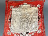 a red pillow with a picture of a man and a woman on it