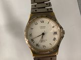 an image of a watch with roman numerals on a bracelet