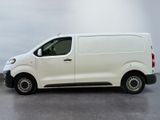 the white van is parked on the concrete floor in the room