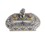 a small figurine sitting on top of a decorative box