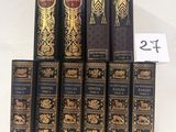 six books are stacked on top of each other on a white surface