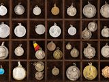 many different types of silver and gold coins in a display case