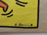 yellow piece of paper with a drawing of a person ' s hand holding a knife