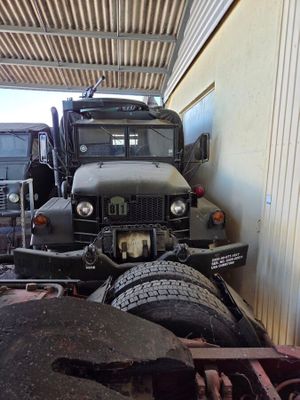 two trucks that are parked next to each other in a garage