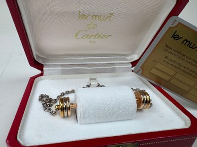 a red box with a silver and gold bracelet inside of it