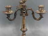 a silver plated candelab with three candles on it
