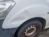 a white van that is parked on the side of the road