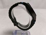 a close up of a watch sitting on top of a plastic stand