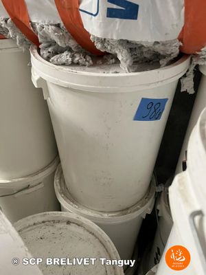 many buckets of cement sitting in the corner of a room