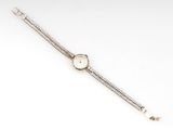 a lady ' s wrist watch with a chain around it