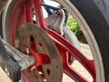 a close up of a motorcycle tire with red rims