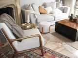 a living room with a couch, chair, coffee table and a fire place