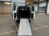 a white van with its door open in a parking lot