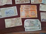 many different types of foreign currency on the table