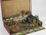 une valise ouverte contenant une maquette de maison