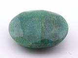 an image of a green stone on a white surface