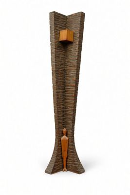 a wooden sculpture of a person standing in a tall vase
