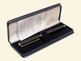 a black pen in a black case with a note in it