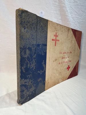 an old book with a red cross on it sitting on a white surface
