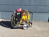 a small yellow machine with a hose attached to it