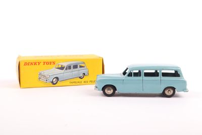 an old toy car is sitting next to a box of dinky toys