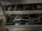 a drawer full of tools in a garage