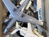 a cardboard box full of toy airplanes and other toys