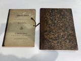 an old book sitting on top of a white table next to a book