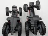 two lego vehicles that are sitting side by side on a white surface