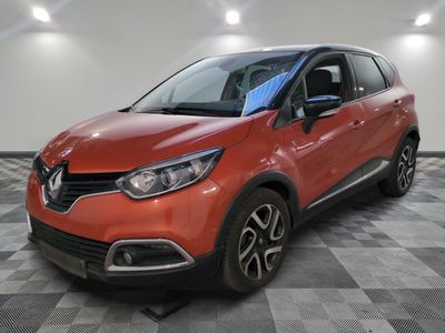 a red car is parked on a checkered floor in a garage