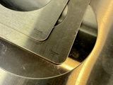 a person cutting a piece of metal with a knife