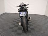 a motorcycle that is parked in a room with a checkered floor