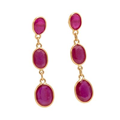 a pair of pink stone earrings on a white background