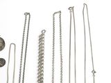 many different types of necklaces on a white surface