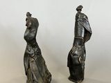 pair of antique bronze figurines of a man and a woman