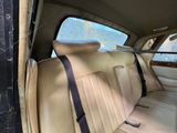 the back seat of a car with a black seat belt