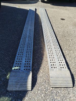 a metal grate laying on the ground next to a truck