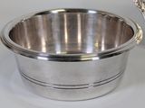 a silver bowl with a lid on a white table